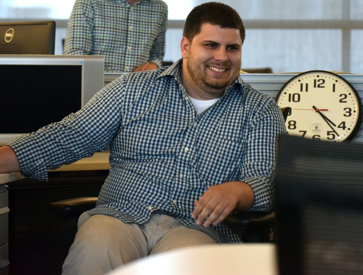 Laughing in the Herald-Tribune newsroom. Photo by Carlos Munoz